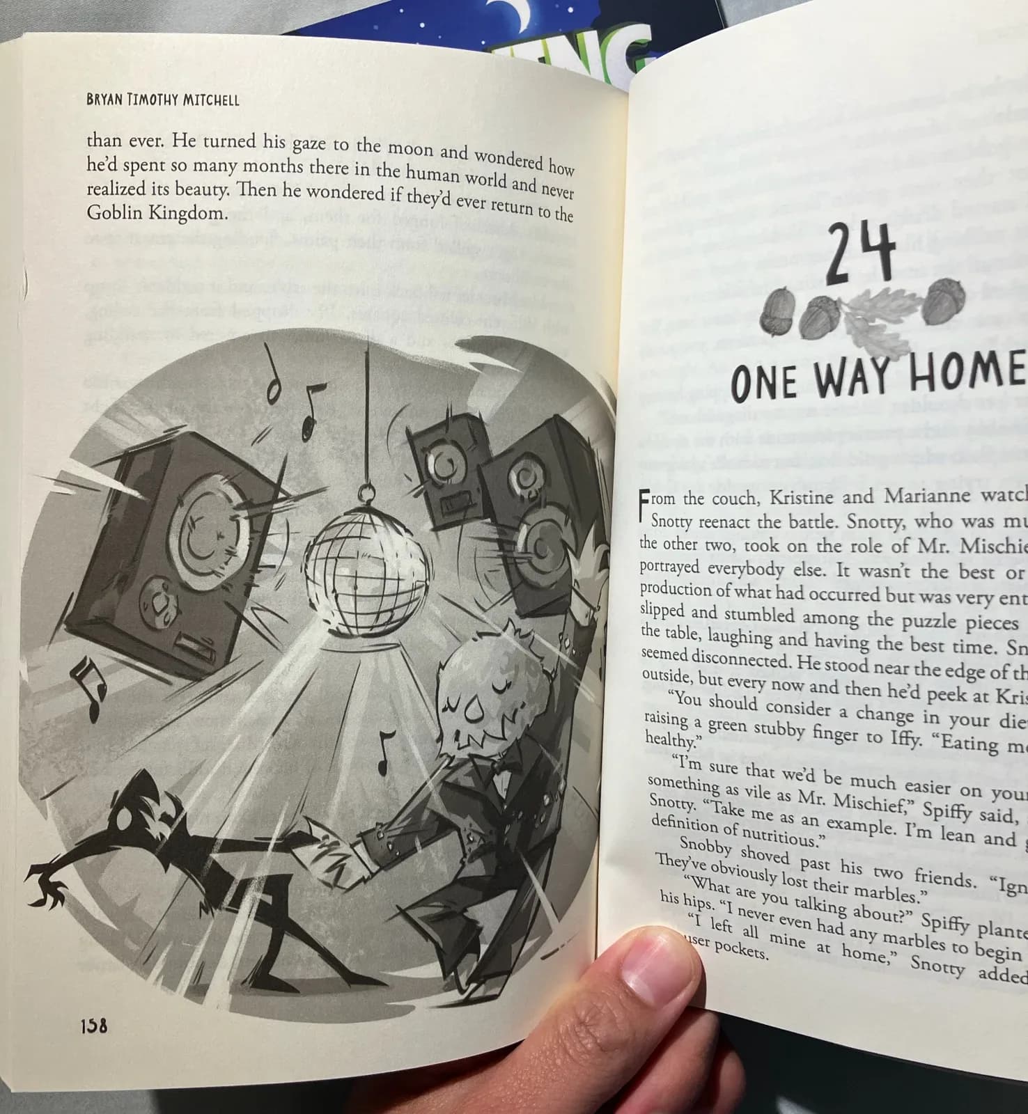 Photo of an open printed copy of Iffy Eats Monsters showing an interior illustration of two goblin characters dancing under a disco ball